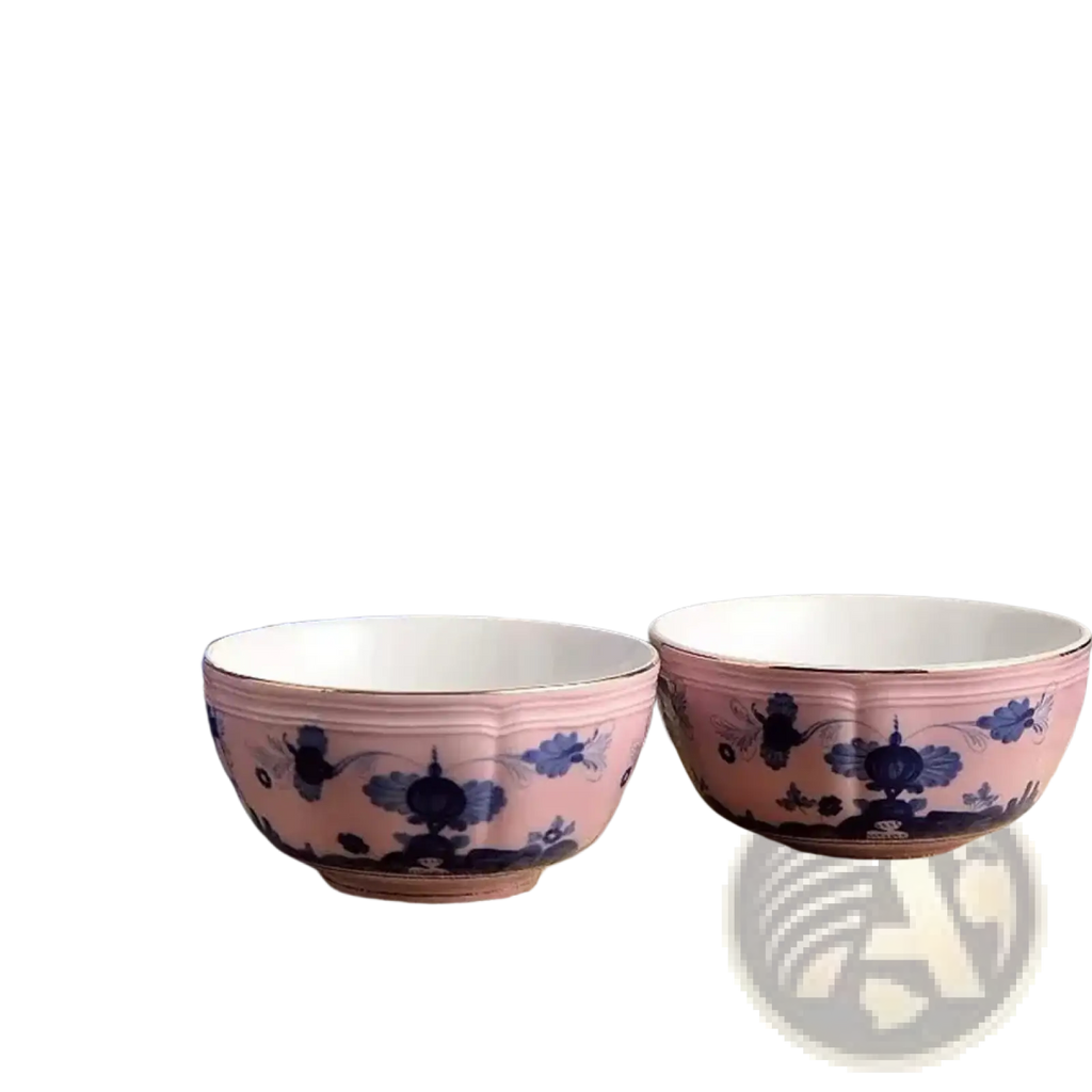 Pink ceramic tea bowls with blue floral and bird motifs and gold-rimmed edges from ceramic floral tableware set