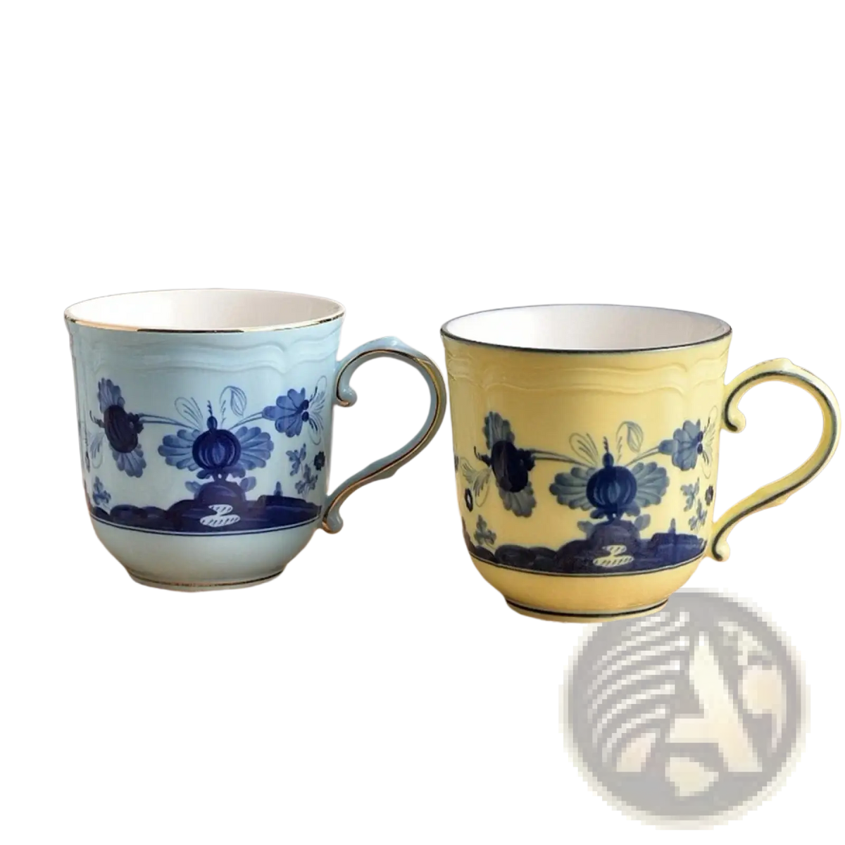 Two elegant porcelain ceramic floral coffee mugs in light blue and yellow with dark blue patterns and gold-trimmed rims