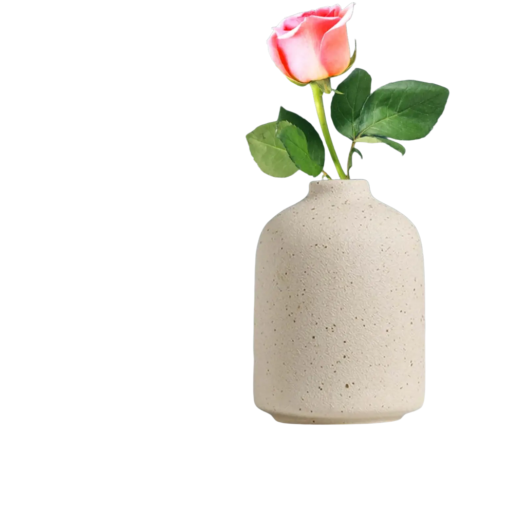 Beige speckled ceramic flower vase holding a single pink rose for boho tabletop decor and flower vase note