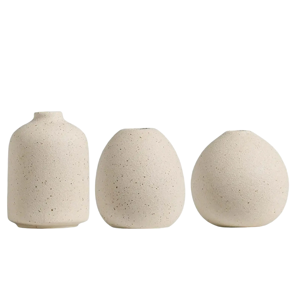 Set of three beige speckled ceramic flower vases with rounded organic shapes for boho tabletop decor