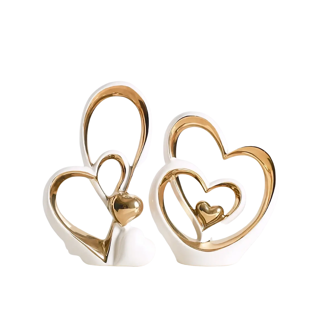 White ceramic heart sculpture with gold metallic heart outlines and smaller golden heart modern luxury decor
