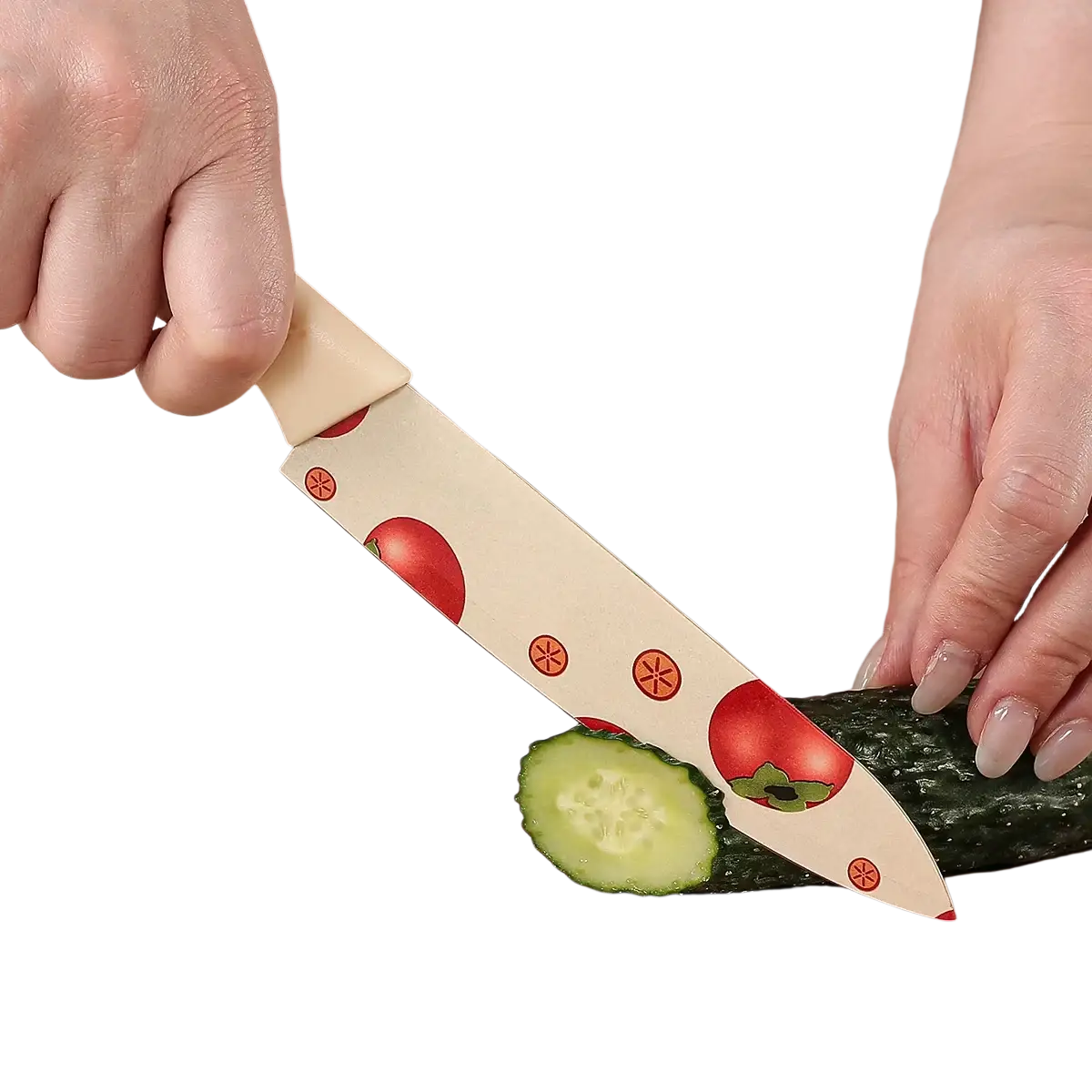 Ceramic kitchen knife set with cream blade featuring red tomato and orange star patterns slicing cucumber