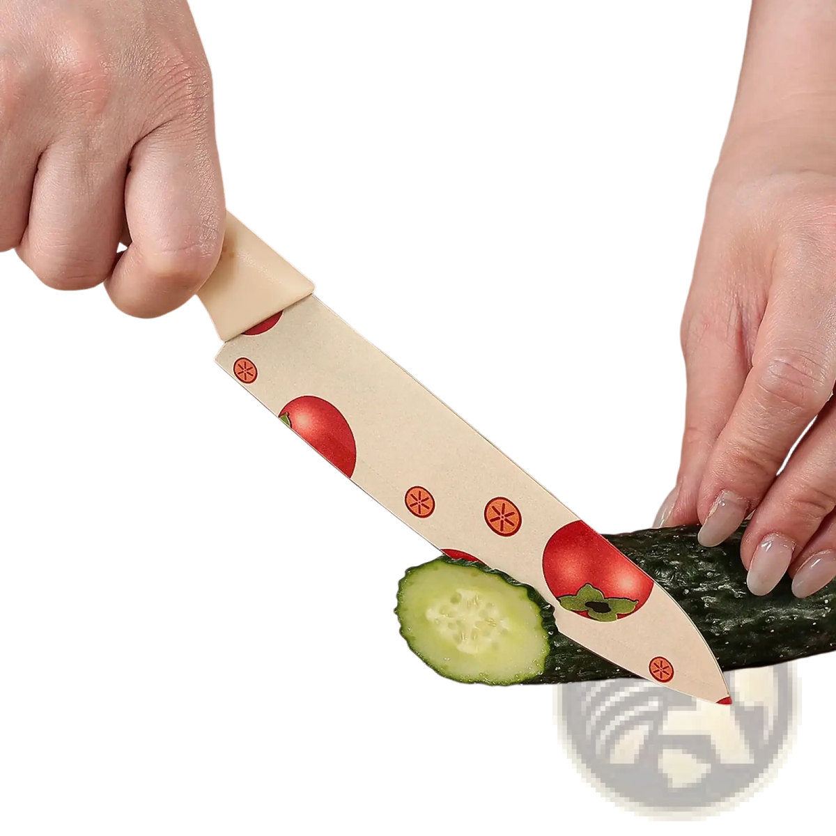 Ceramic kitchen knife set with cream blade featuring red tomato and orange star patterns slicing cucumber