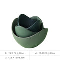 Set of three nested ceramic lotus bowls in varying green shades with smooth curved edges and matte finish