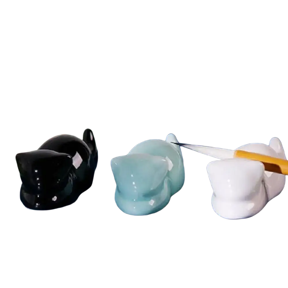Three glossy ceramic cat-shaped pen holders in black light blue and white minimalist calligraphy brush rests
