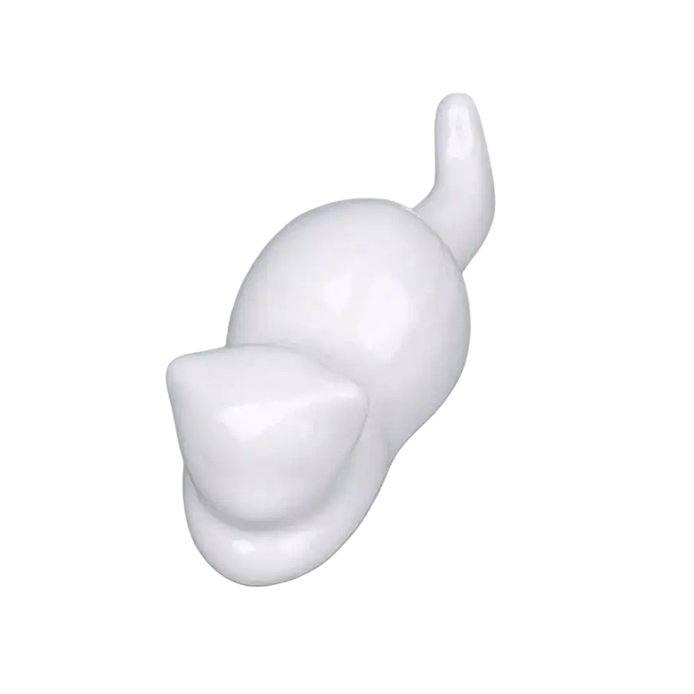 White ceramic cat-shaped hook with a smooth glossy finish used as a minimalist calligraphy brush rest