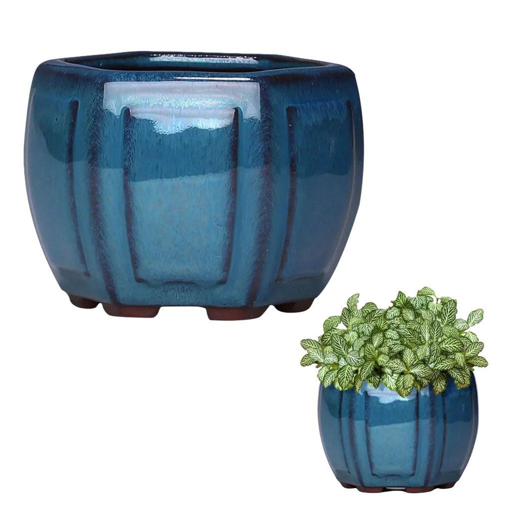 Deep blue glazed ceramic plant pot with vertical ribbed texture rounded feet and drainage hole for indoor plants