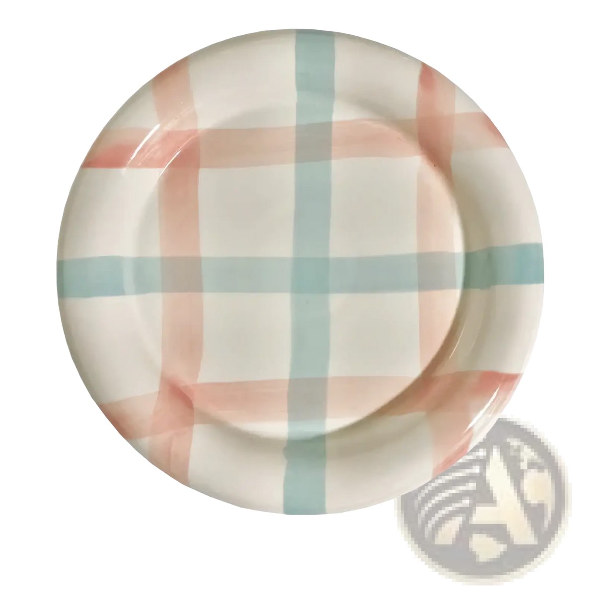 A round ceramic plate with a pastel blush pink and mint green plaid pattern for decorative kitchenware