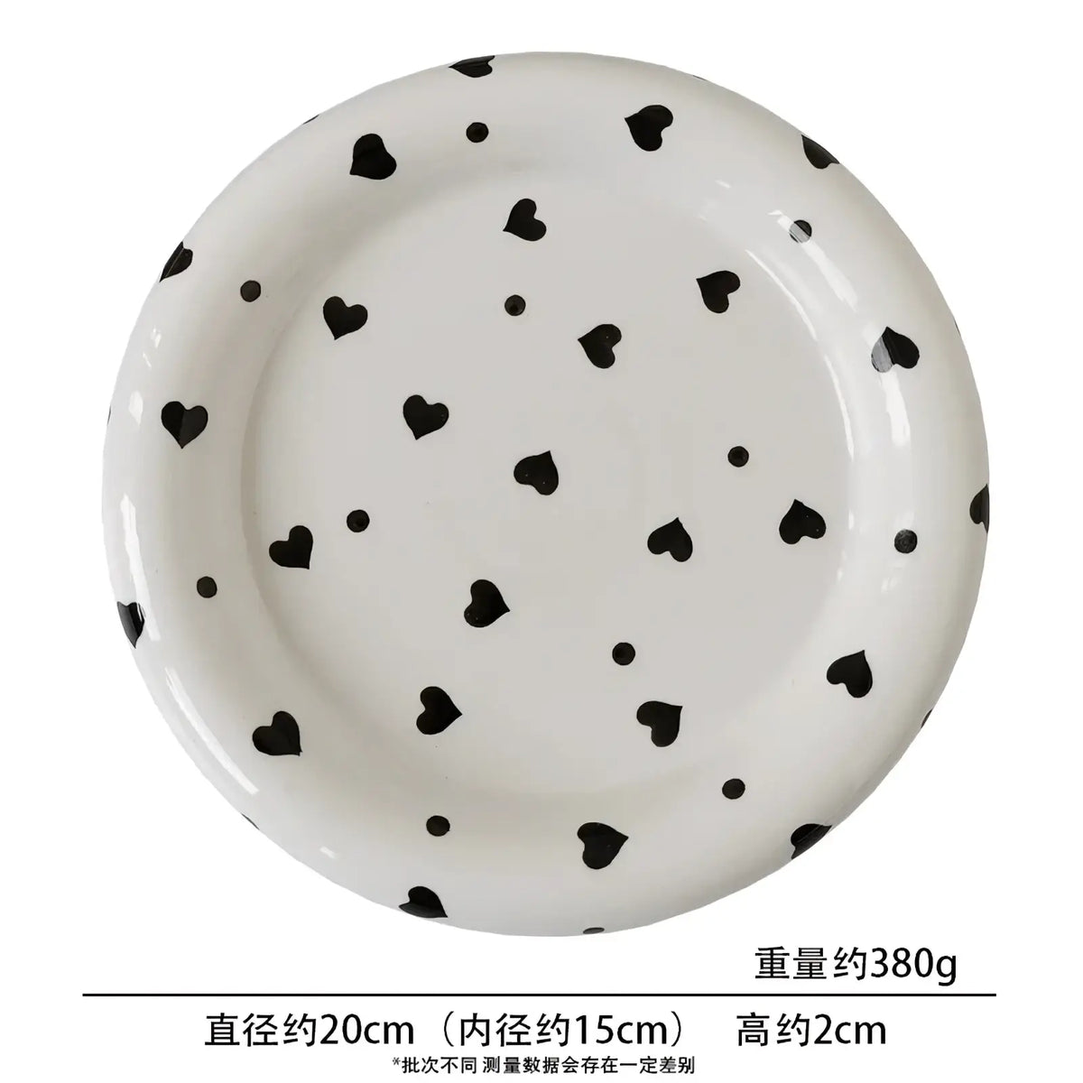 White ceramic plate with a glossy finish featuring black heart and dot patterns for decorative tableware use