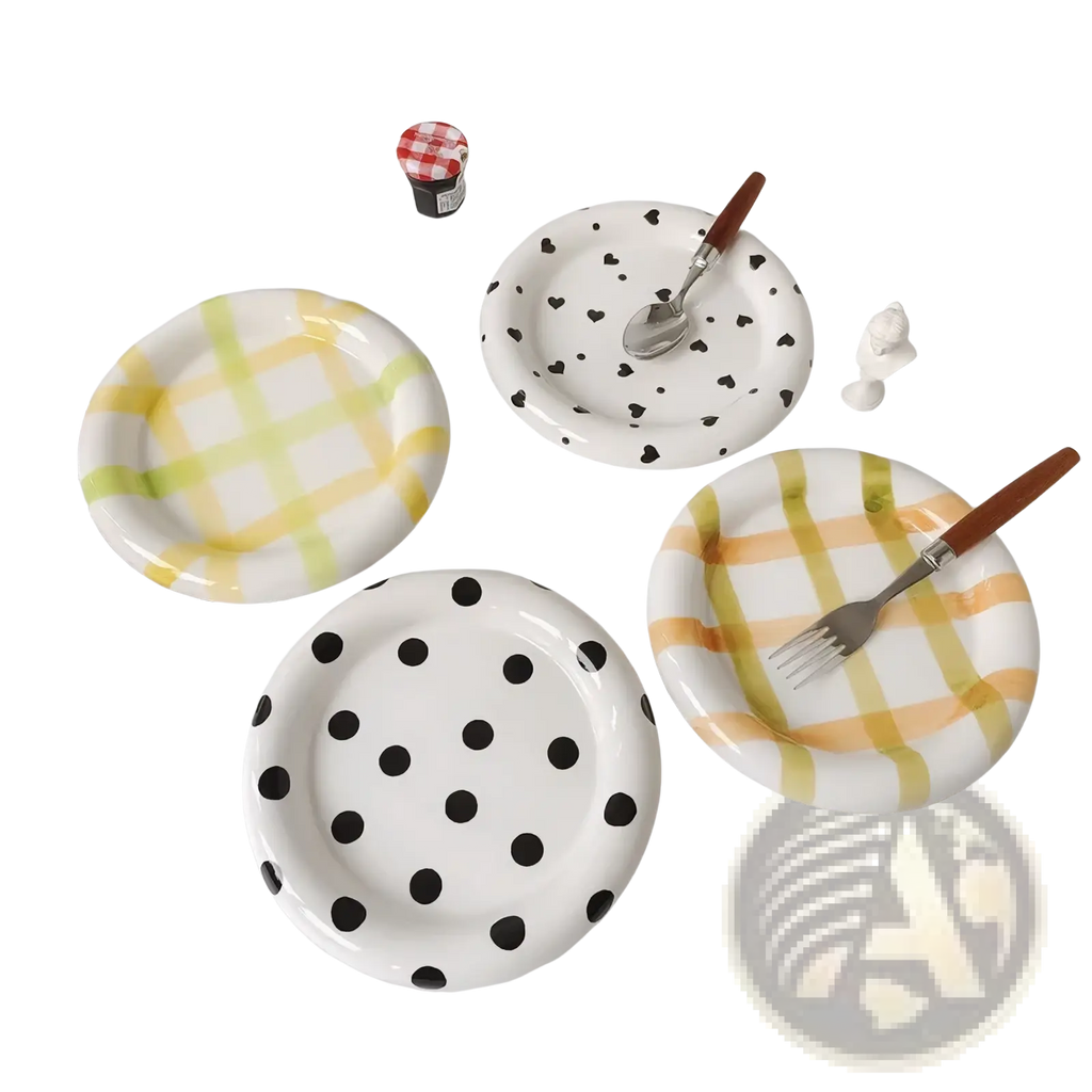 Set of four ceramic plates with playful yellow checkered, black polka dots, orange green plaid, and heart patterns