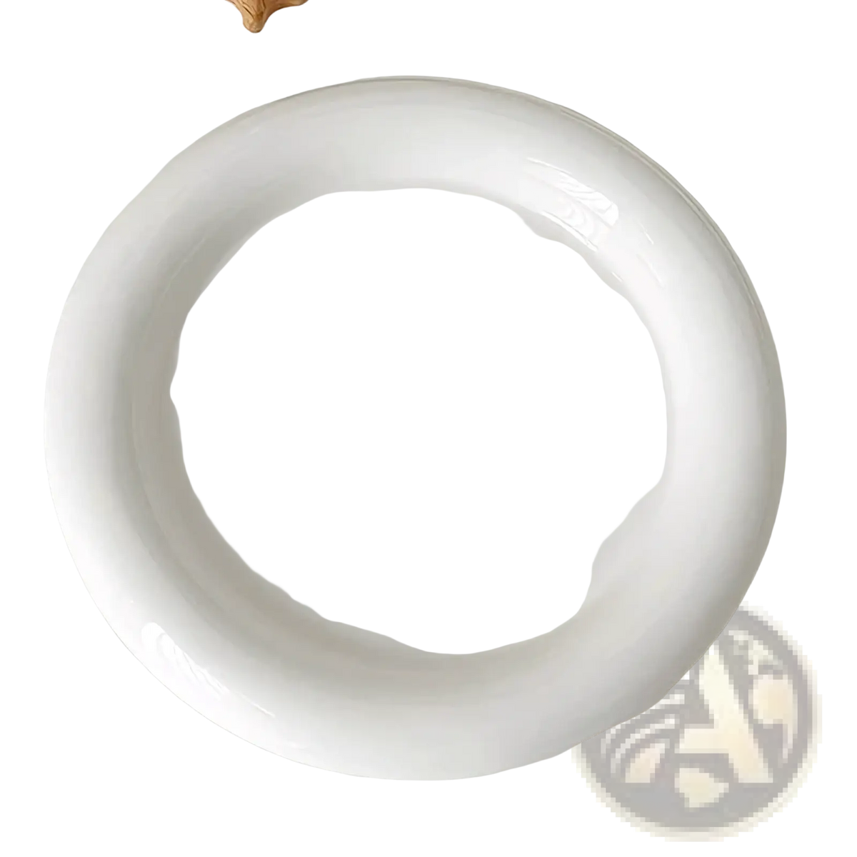 A minimalist white ceramic plate with a smooth glossy finish and raised rim for decorative tableware and kitchenware