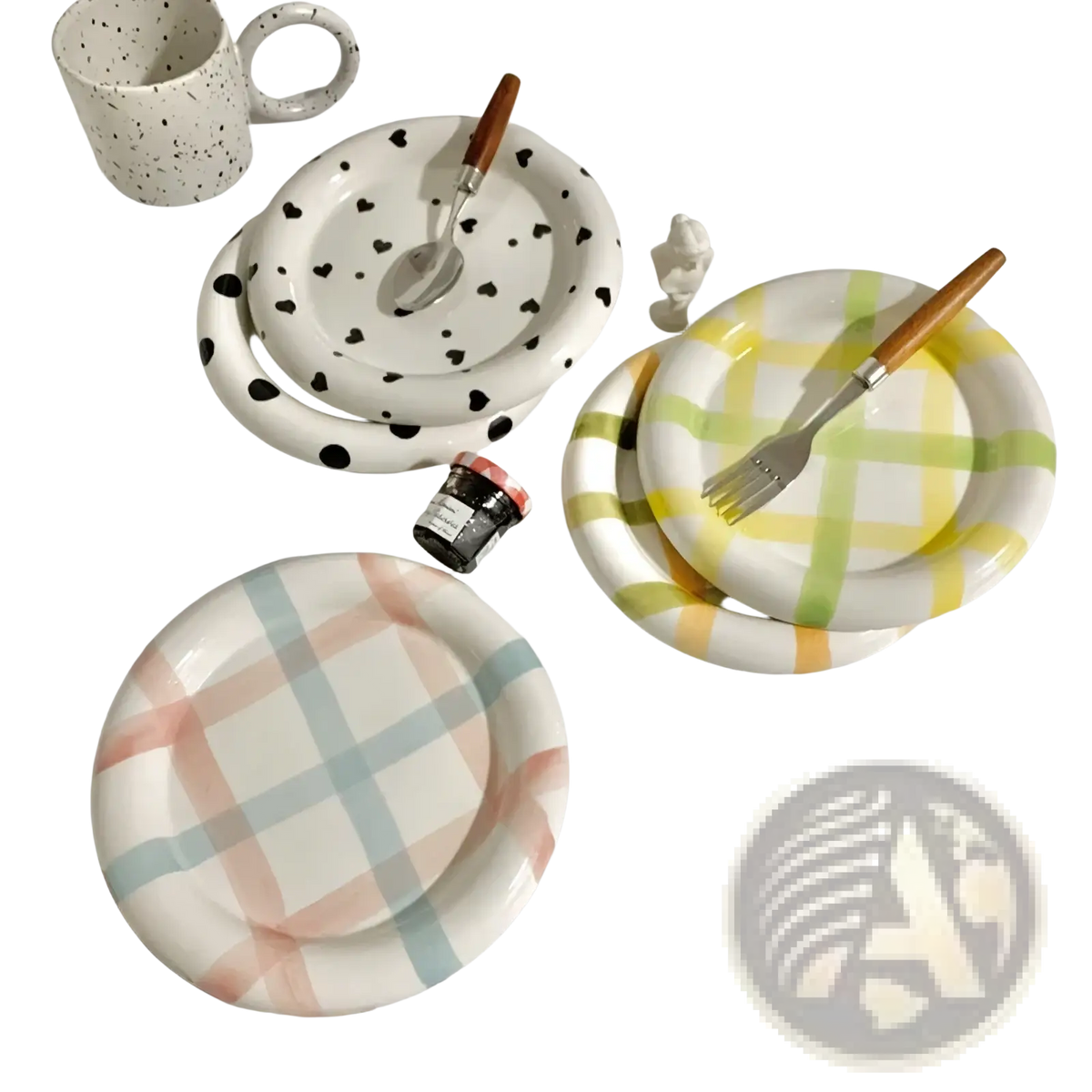 Set of three ceramic plates with playful black heart, yellow green plaid, and pastel checkered patterns with wooden utensils