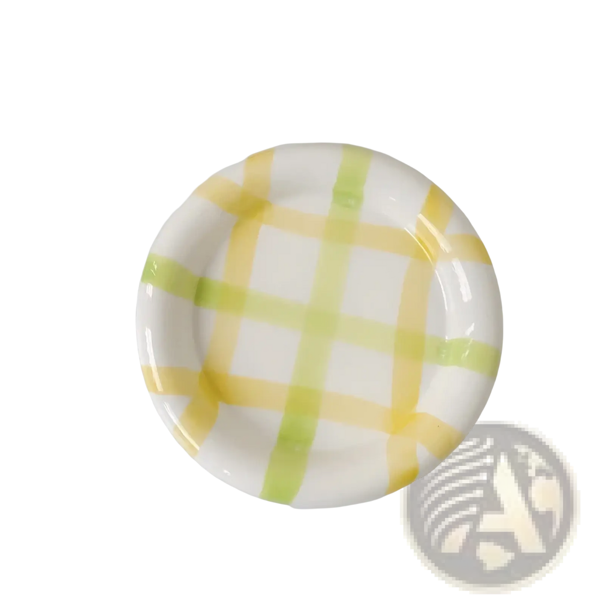 A white ceramic plate with a hand-painted yellow and light green checkered pattern for decorative kitchenware
