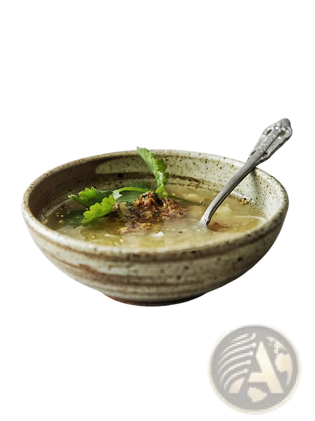 Earthenware bowl from ceramic rustic speckled stoneware set with beige glaze and cilantro garnished light broth