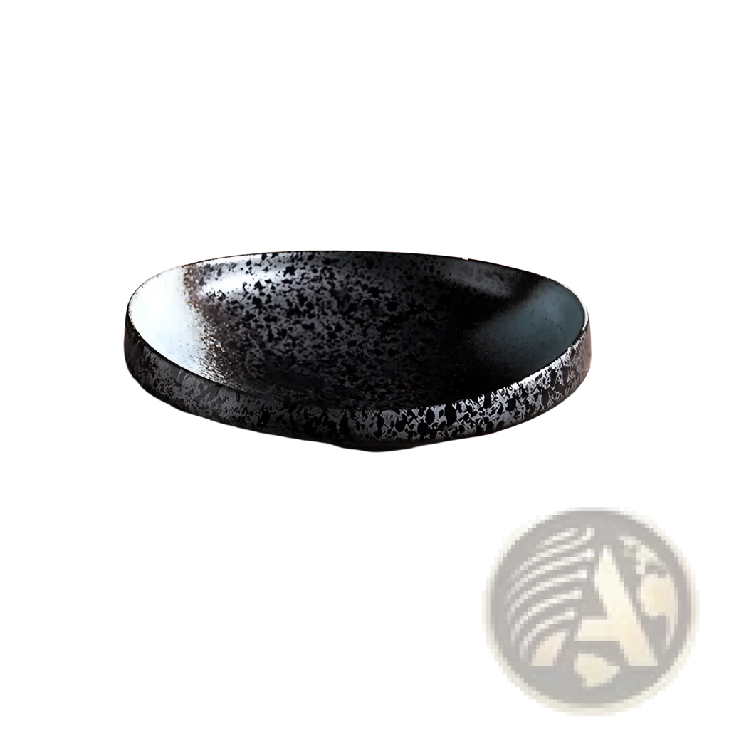 A sleek black ceramic speckled serving bowl with a glossy finish on a rustic wooden surface for home kitchens