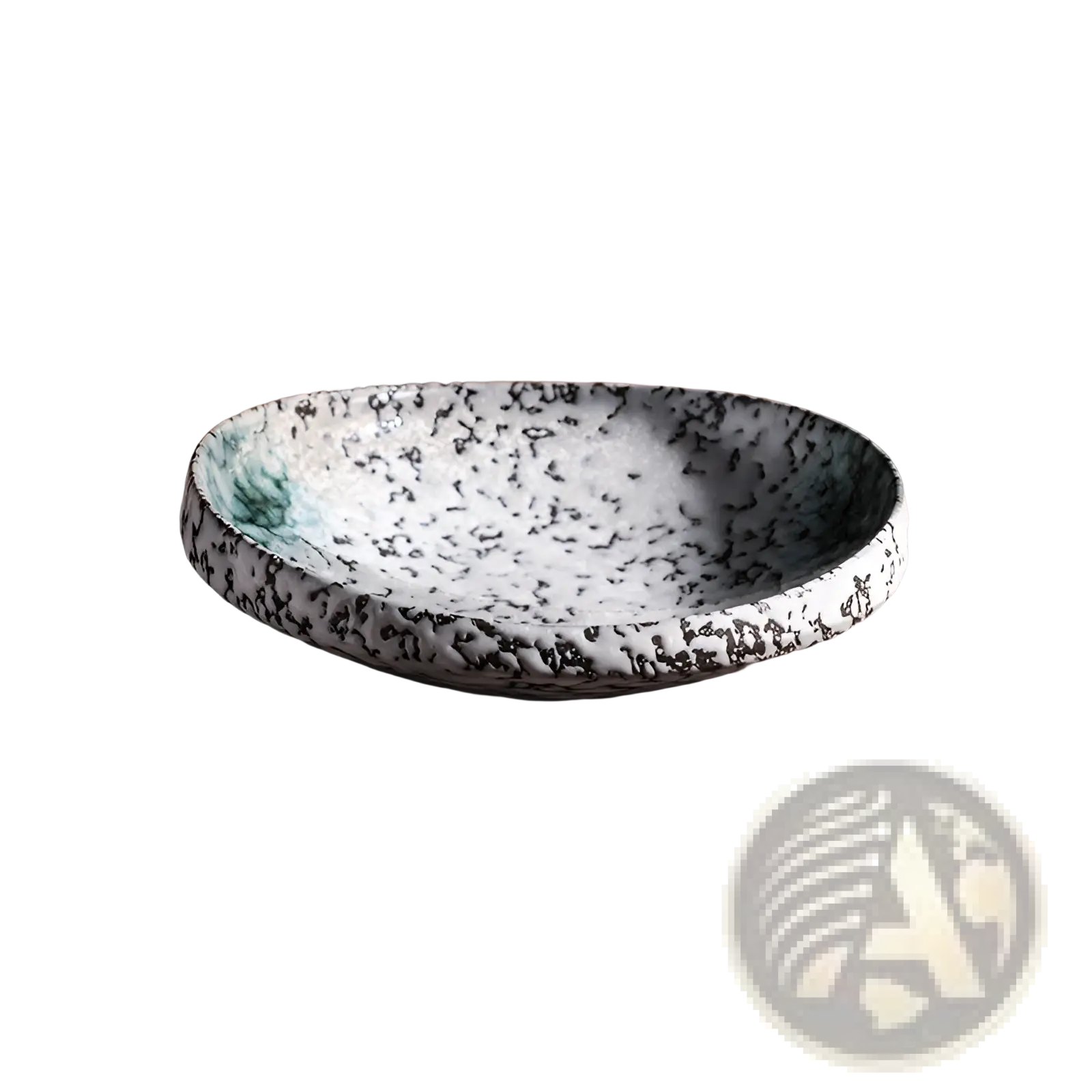 A white ceramic speckled serving bowl with black glaze and green accents on a rustic wooden surface