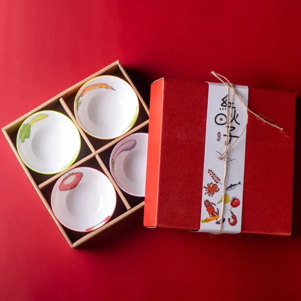 Set of four hand-painted marine ceramic bowls with colorful vegetable and seafood illustrations in a wooden gift box