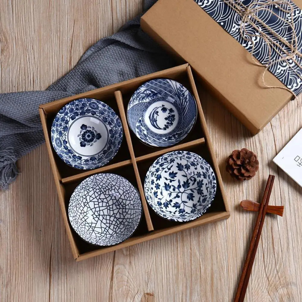 Set of four hand-painted blue and white marine ceramic bowls with intricate floral patterns and crackle glaze finish in wooden box