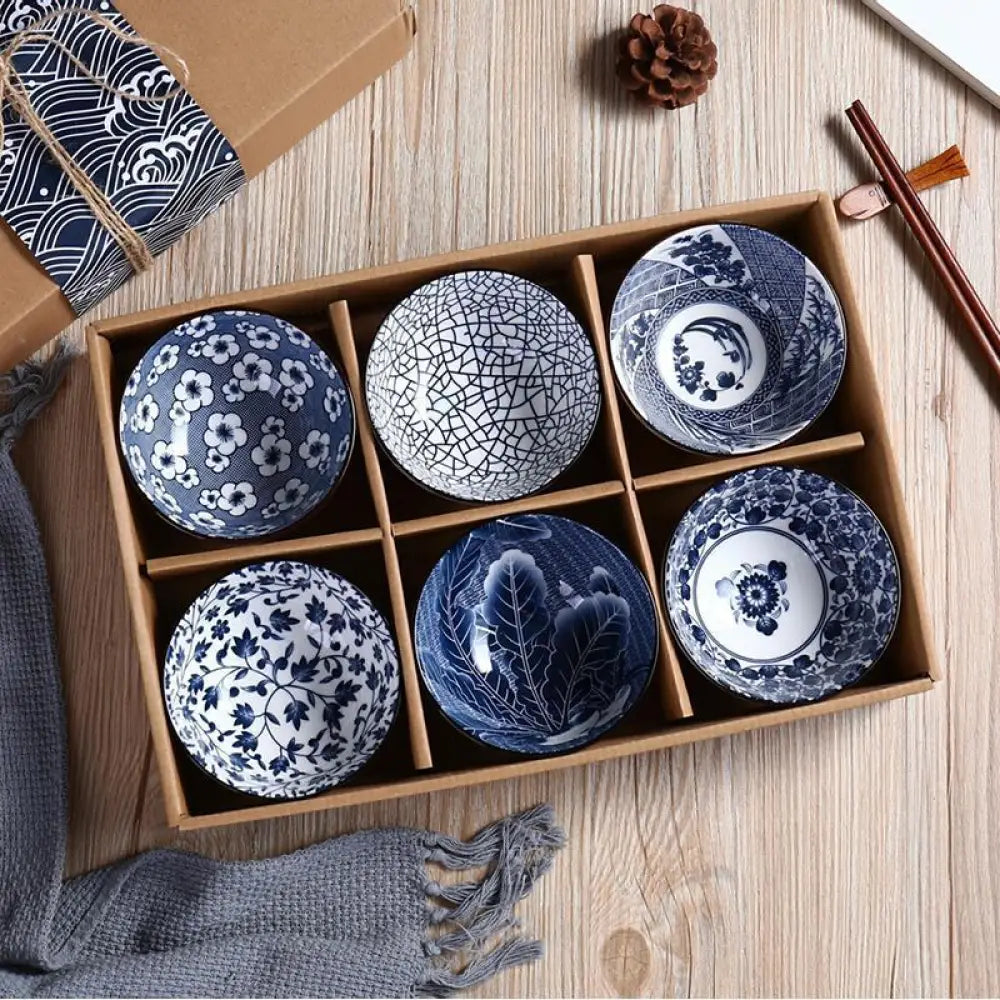 Set of six hand-painted blue and white marine ceramic bowls with intricate patterns arranged in wooden gift box