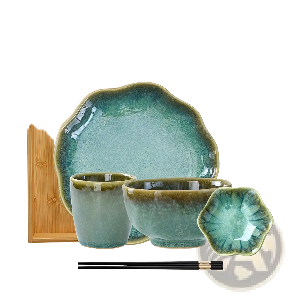Set of ceramic tableware with crackled teal glaze and scalloped edges including plates bowls cups and a dish