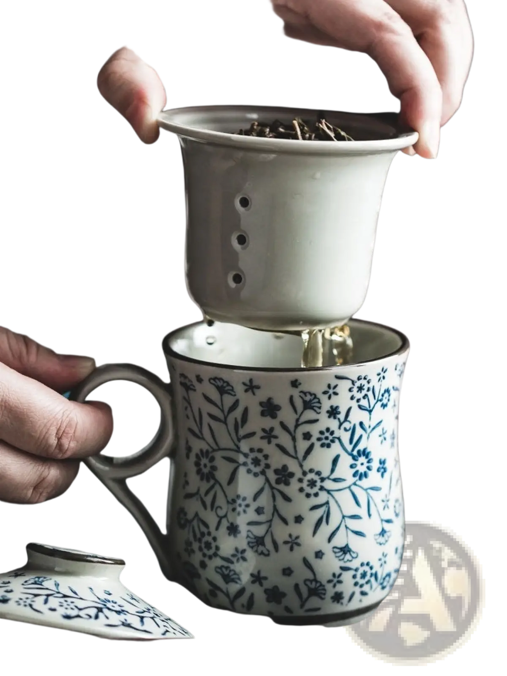 A delicate blue and white ceramic tea mug with floral pattern and matching infuser strainer on top 300ml