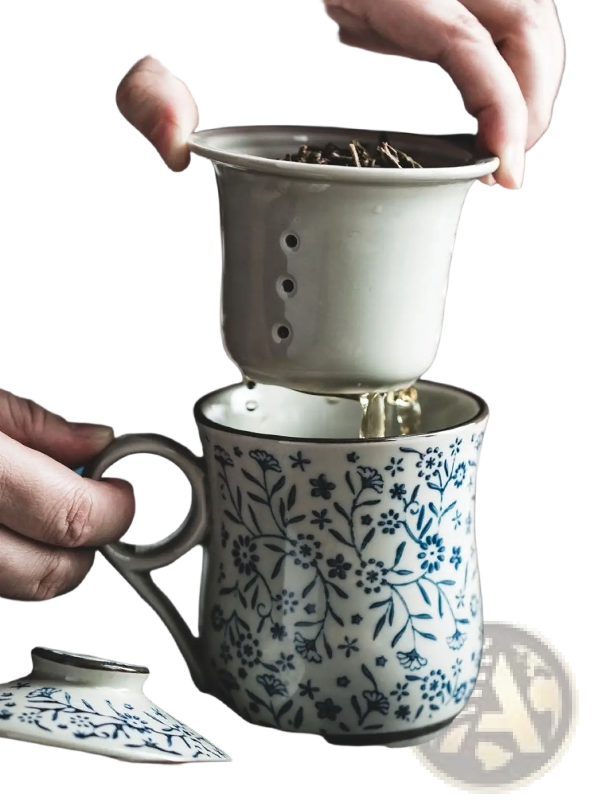 A delicate blue and white ceramic tea mug with floral pattern and matching infuser strainer on top 300ml