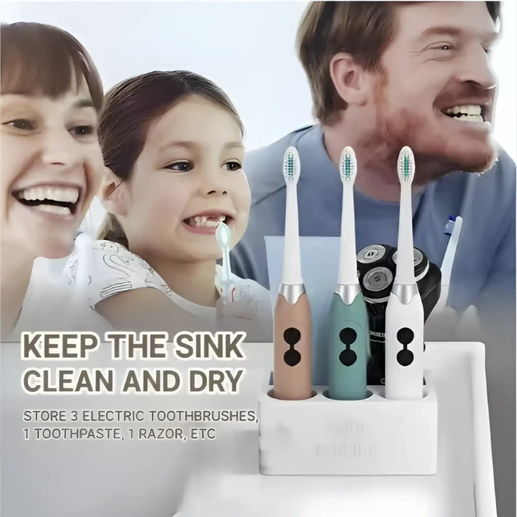 White ceramic toothpaste holder with marble finish holding three electric toothbrushes in beige teal and silver colors