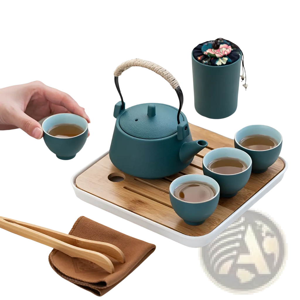 Teal ceramic travel tea set with woven handle and matching cups arranged on a bamboo tray for serving tea
