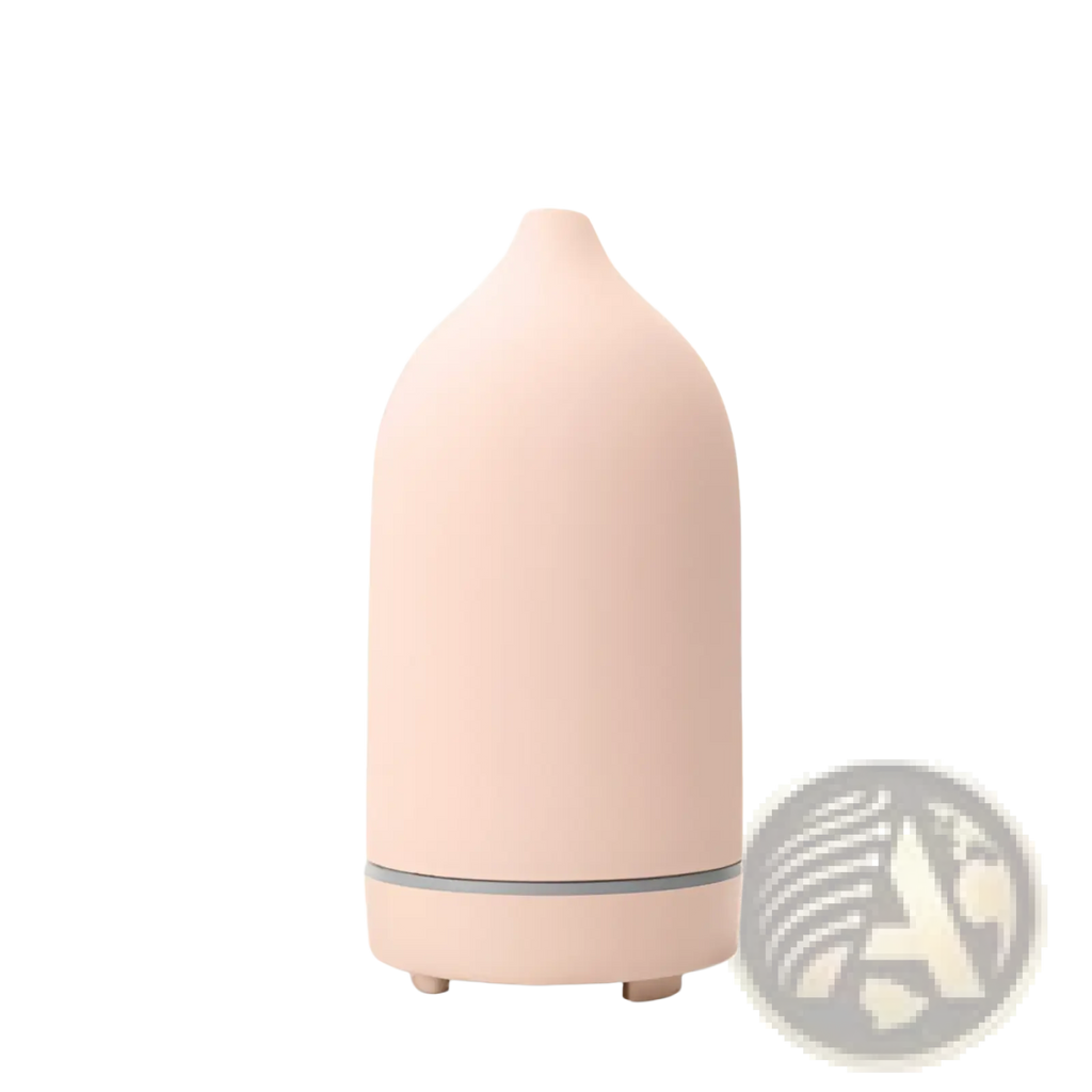A sleek blush-pink ceramic ultrasonic aroma diffuser and humidifier with minimalist design and gray accent band