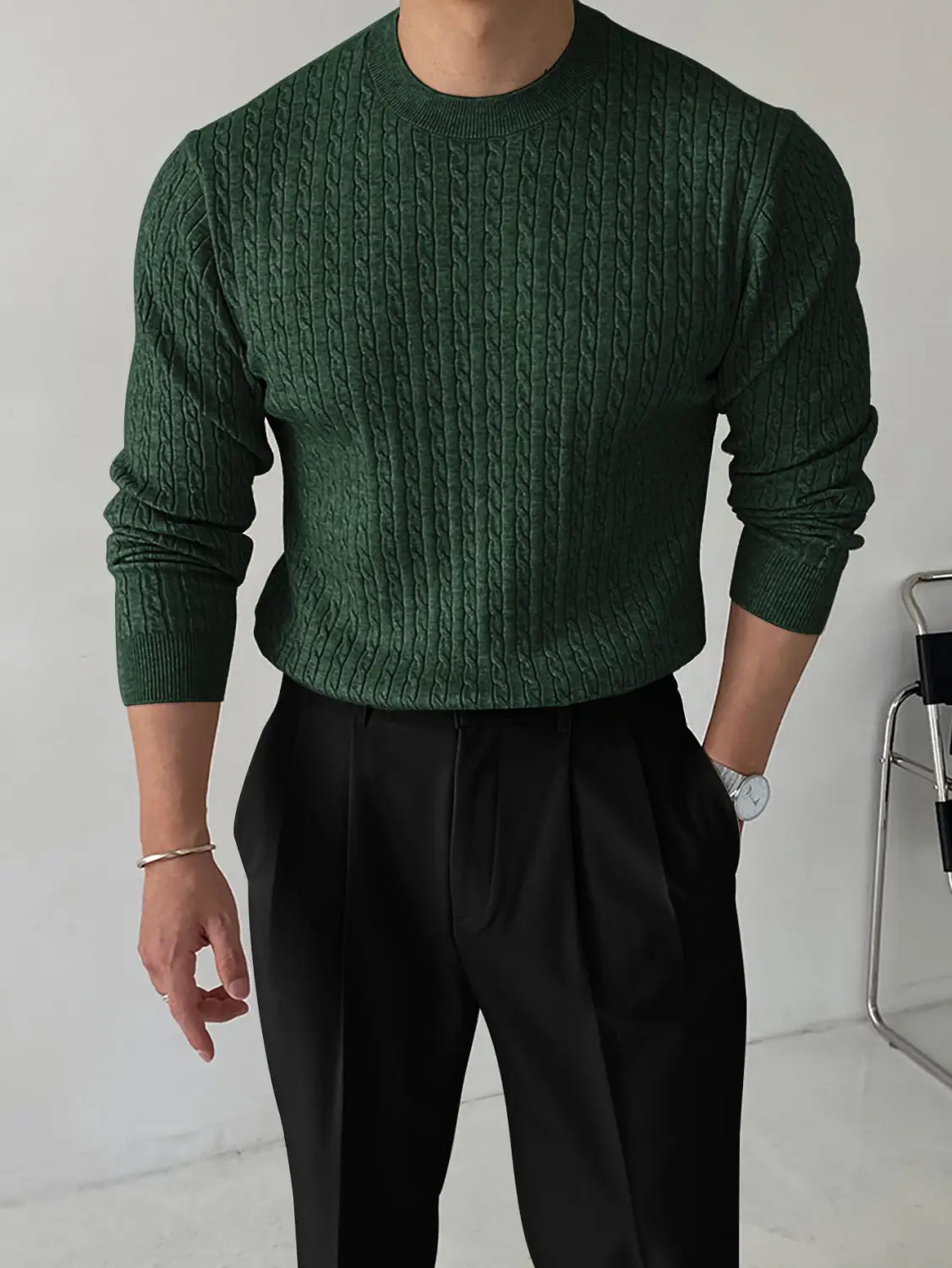 Dark green thick cable-knit sweater for men featuring a ribbed crew neckline and long sleeves.