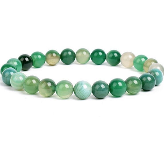 A delicate unisex 8mm polished agate and amethyst stretch bracelet featuring smooth round green agate beads in shades from deep emerald to pale mint.
