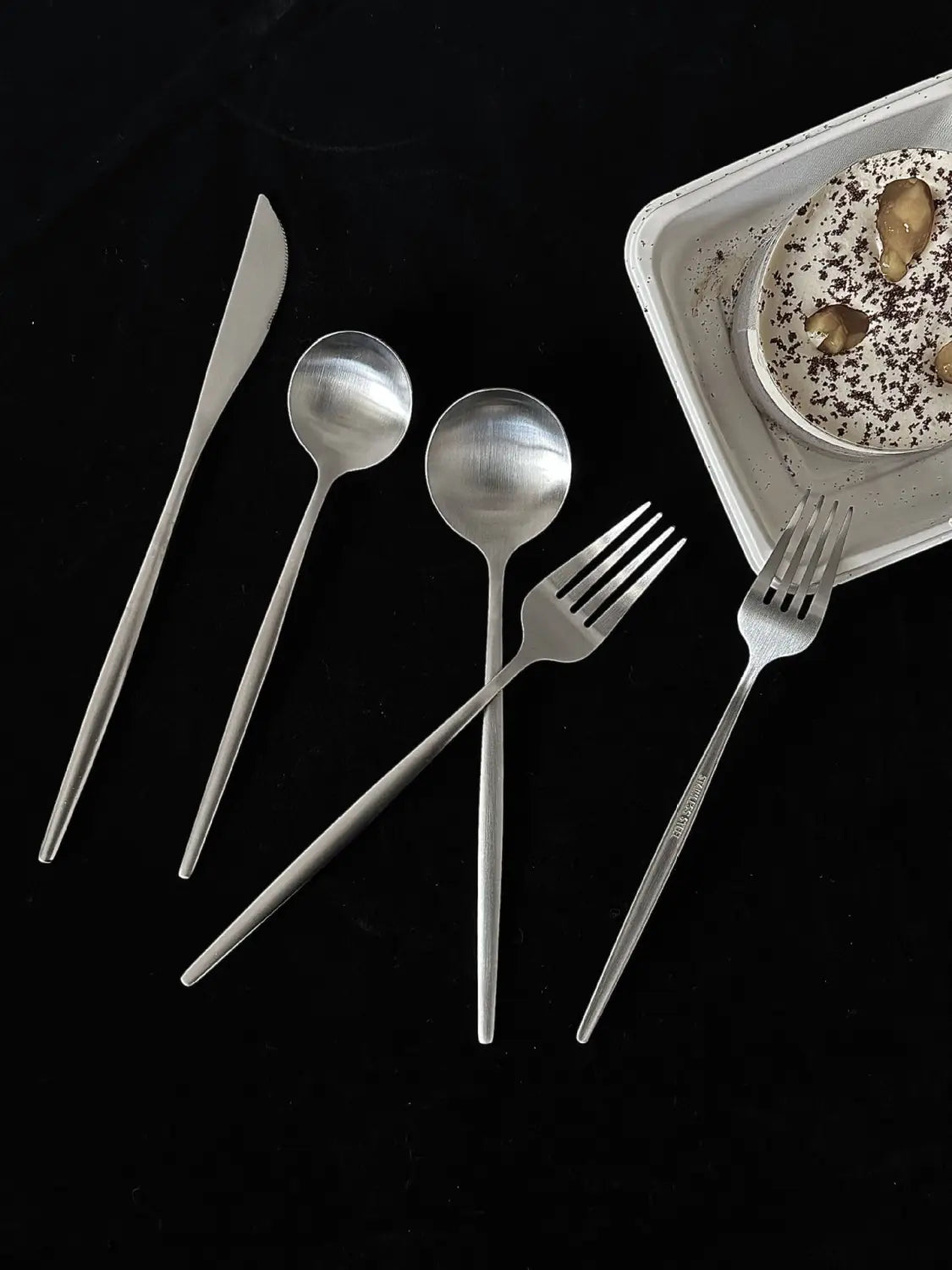 set of minimalist silver-toned stainless steel cutlery featuring a sleek modern design in a stainless steel matte cutlery set minimalist flatware.
