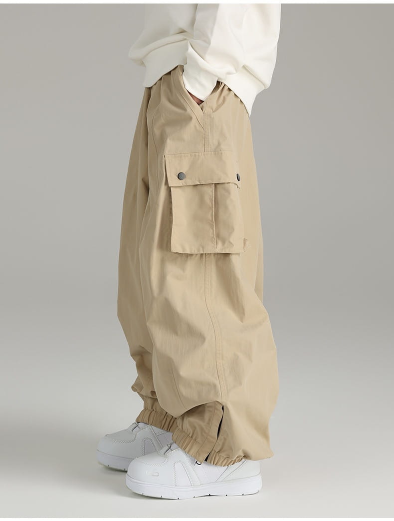 Beige winter outdoor loose ski pants featuring multiple cargo pockets and elastic cuffs for enhanced comfort and functionality.