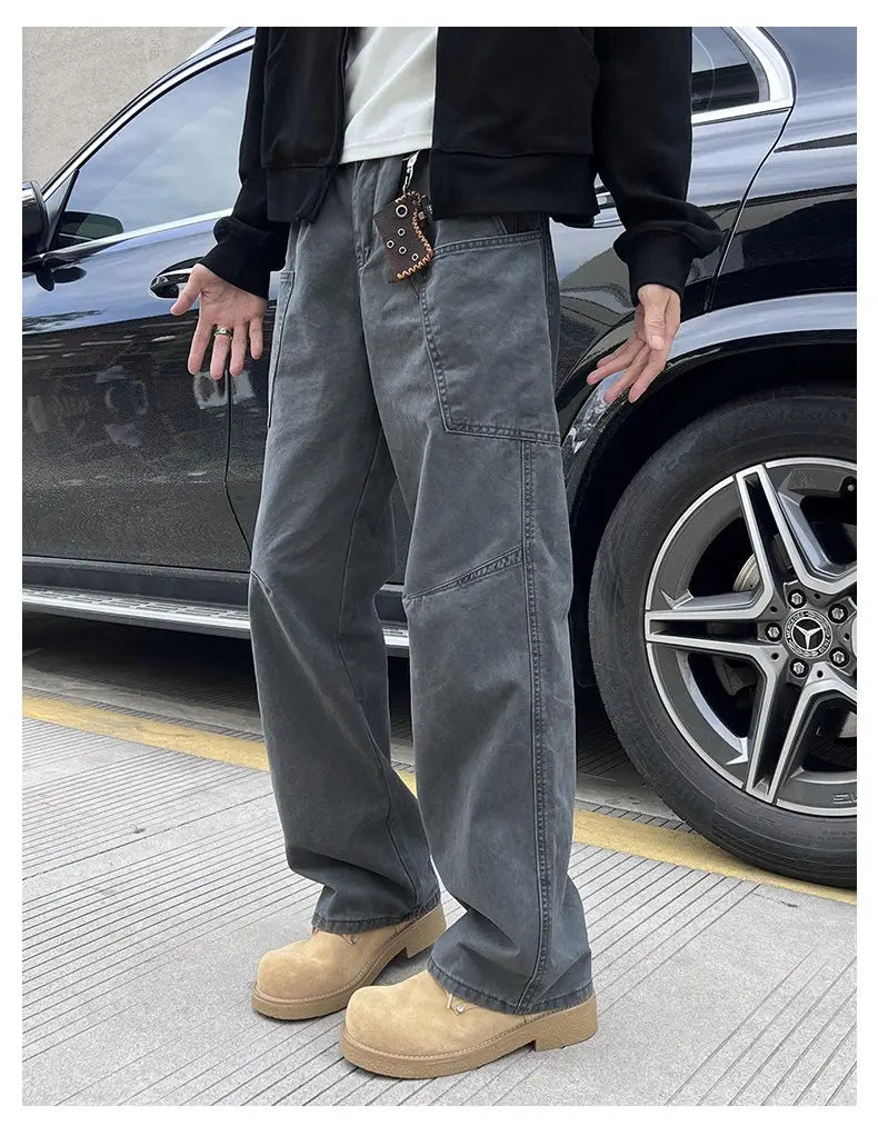 dark gray wide-leg denim cargo pants for men with multiple pockets and a slightly worn texture designed for workwear use