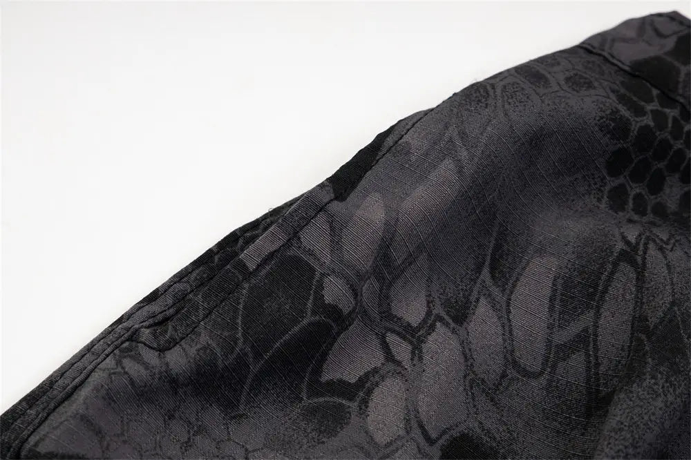 Black fabric with a subtle textured snake scale pattern featured on camouflage cargo pants wide leg tactical trousers.