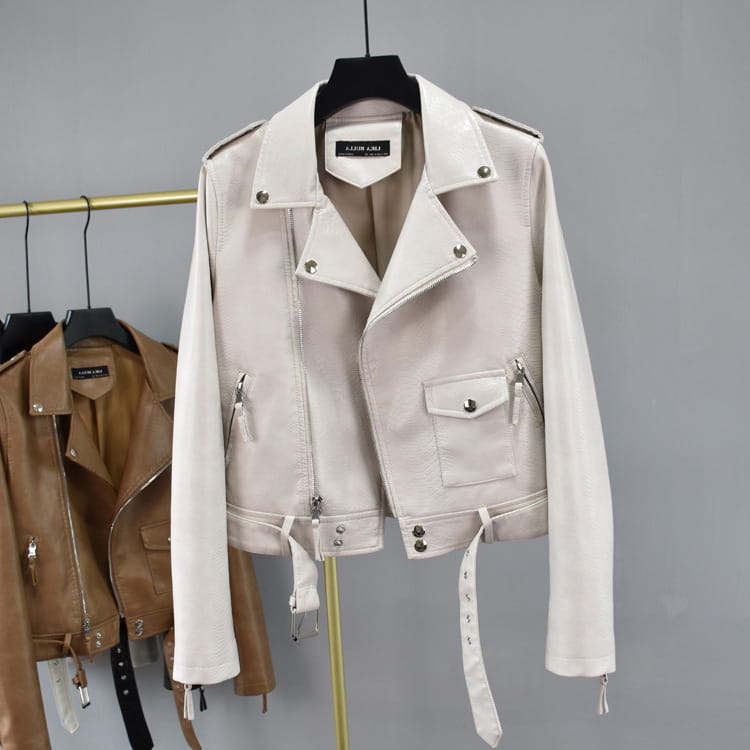 A cream-colored crocodile faux leather cropped biker jacket with silver-toned hardware and a belted waist.