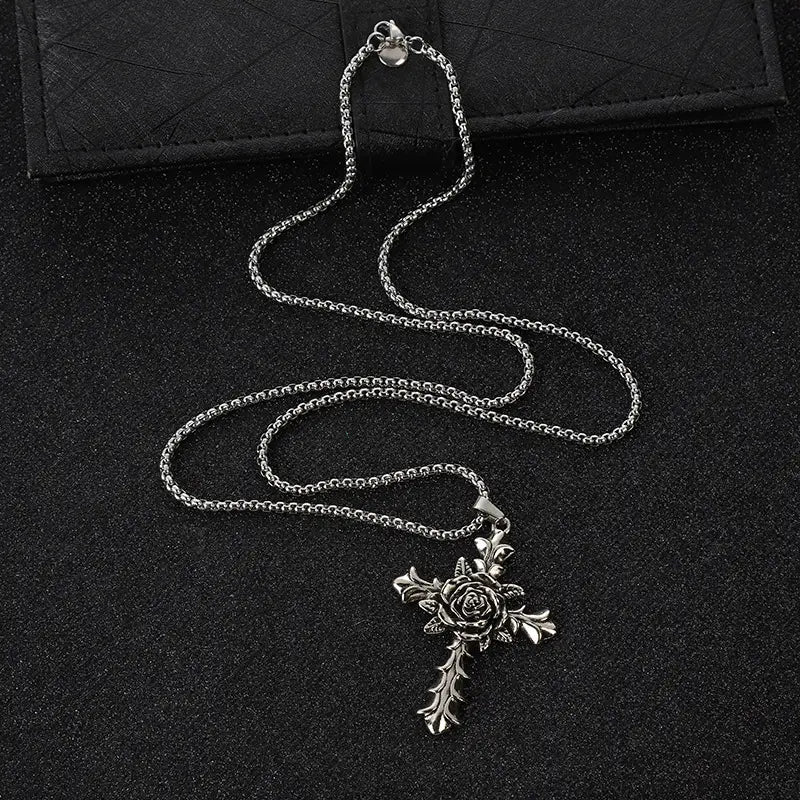 Detailed silver rose cross pendant necklace featuring a textured silver chain and intricate floral design.