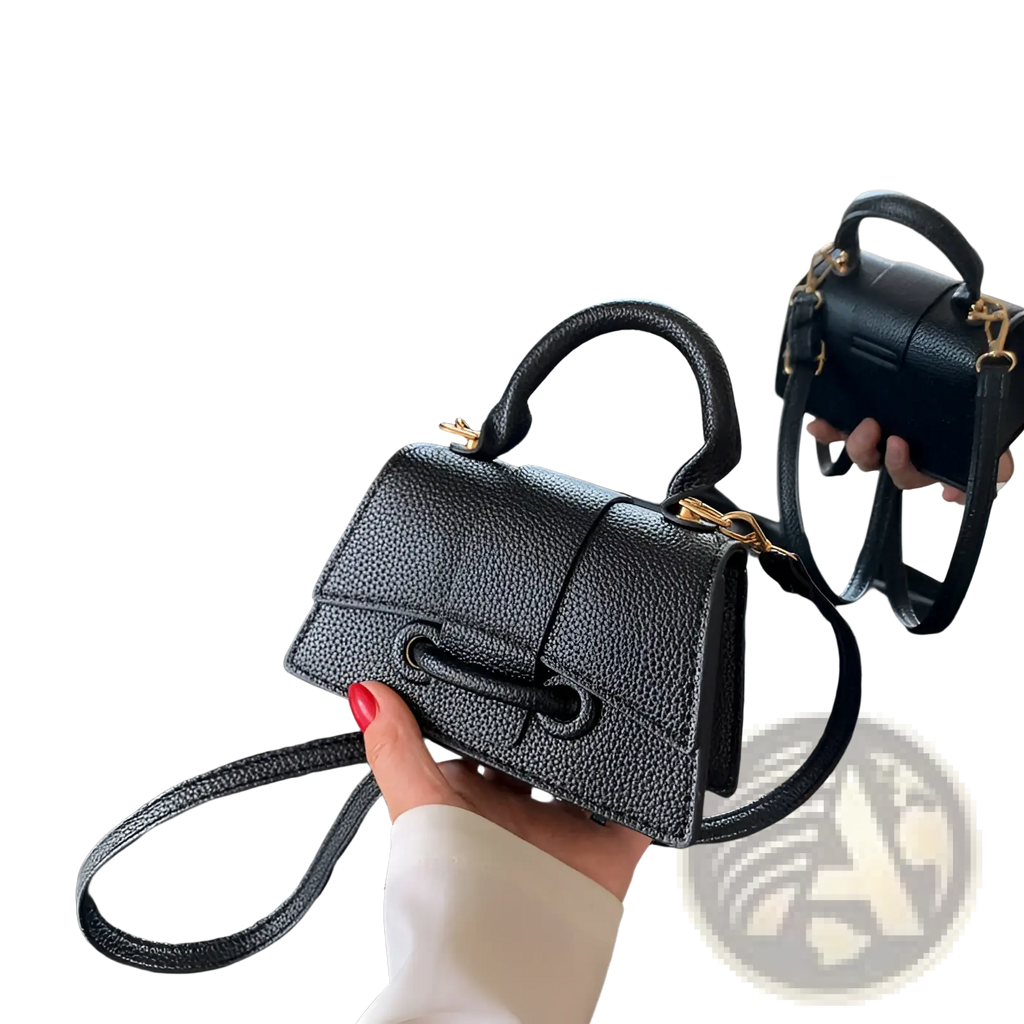 Black pebbled leather mini chain messenger bag with gold tone hardware and top handle for casual use