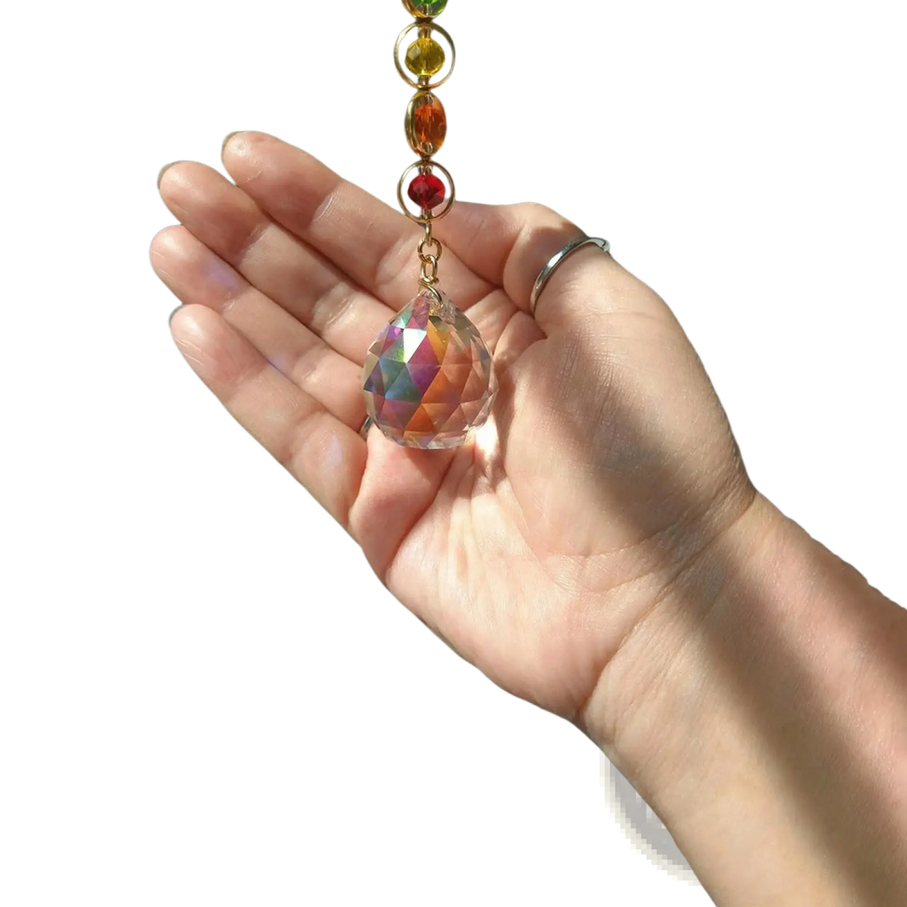 Chakra rainbow crystal sun catcher with a clear faceted prism pendant, gold chain, and colorful gemstone beads