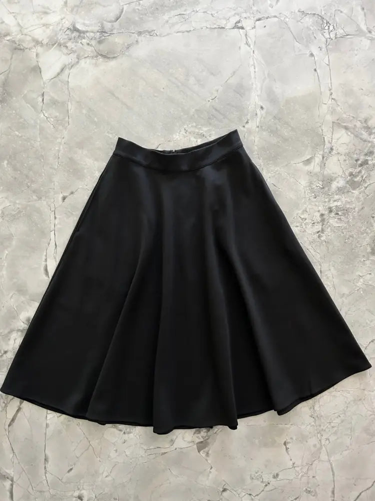 Charlotte Nova black high waisted pleated skirt made of satin with a high waistband for elegant wear