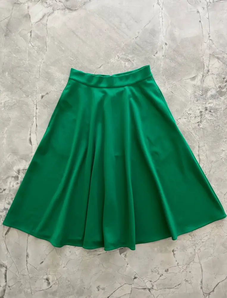 Charlotte Nova emerald green high waisted a-line skirt made of smooth satin-like fabric with a vibrant emerald color