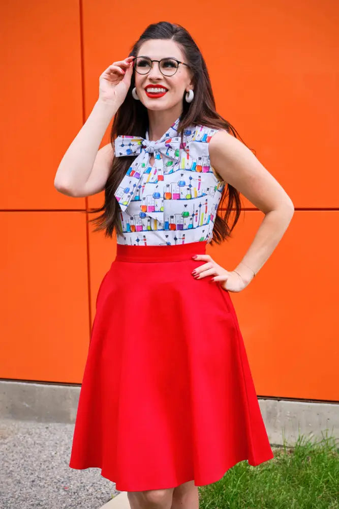 A vibrant red vintage high waisted a line skirt with smooth fabric and pockets by Charlotte