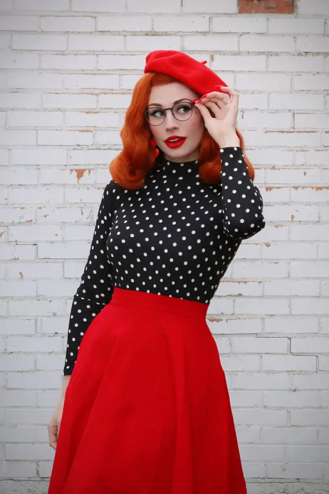 Red beret with a soft structured crown and slightly curved brim paired with charlotte red vintage high waisted circle skirt with pockets