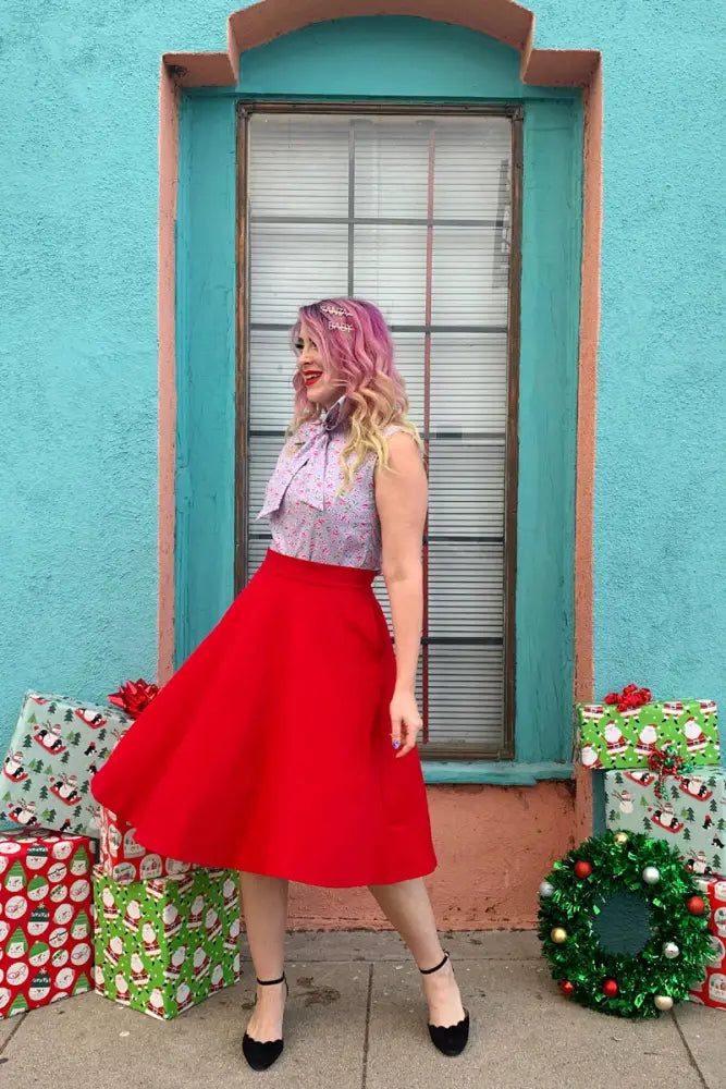 A vibrant red vintage high waisted a-line circle skirt with smooth fabric fitted waistband and pockets