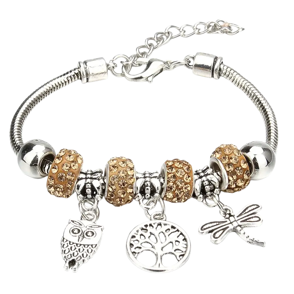 Charm bracelet featuring a silver snake chain with gold-toned crystal beads and silver owl and dragonfly charms
