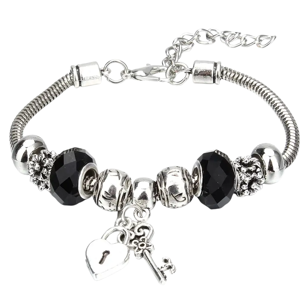 Charm bracelet with silver snake chain adorned with black faceted beads and ornate heart lock and key charms