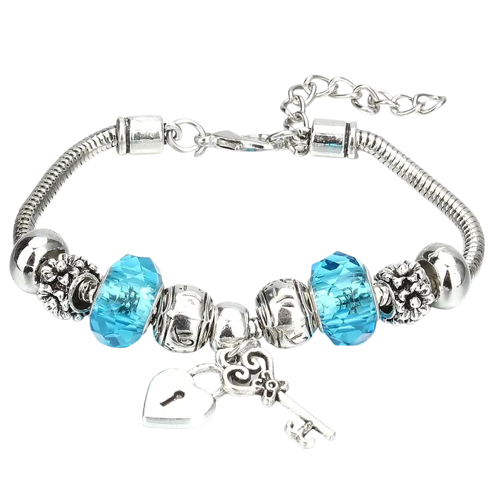 Charm bracelet with silver snake chain featuring vibrant blue crystal beads and silver heart lock and key charms