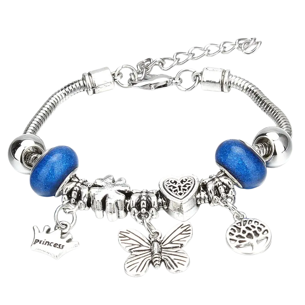 Silver-toned charm bracelet with blue glass beads and metallic charms including crown engraved with princess and key