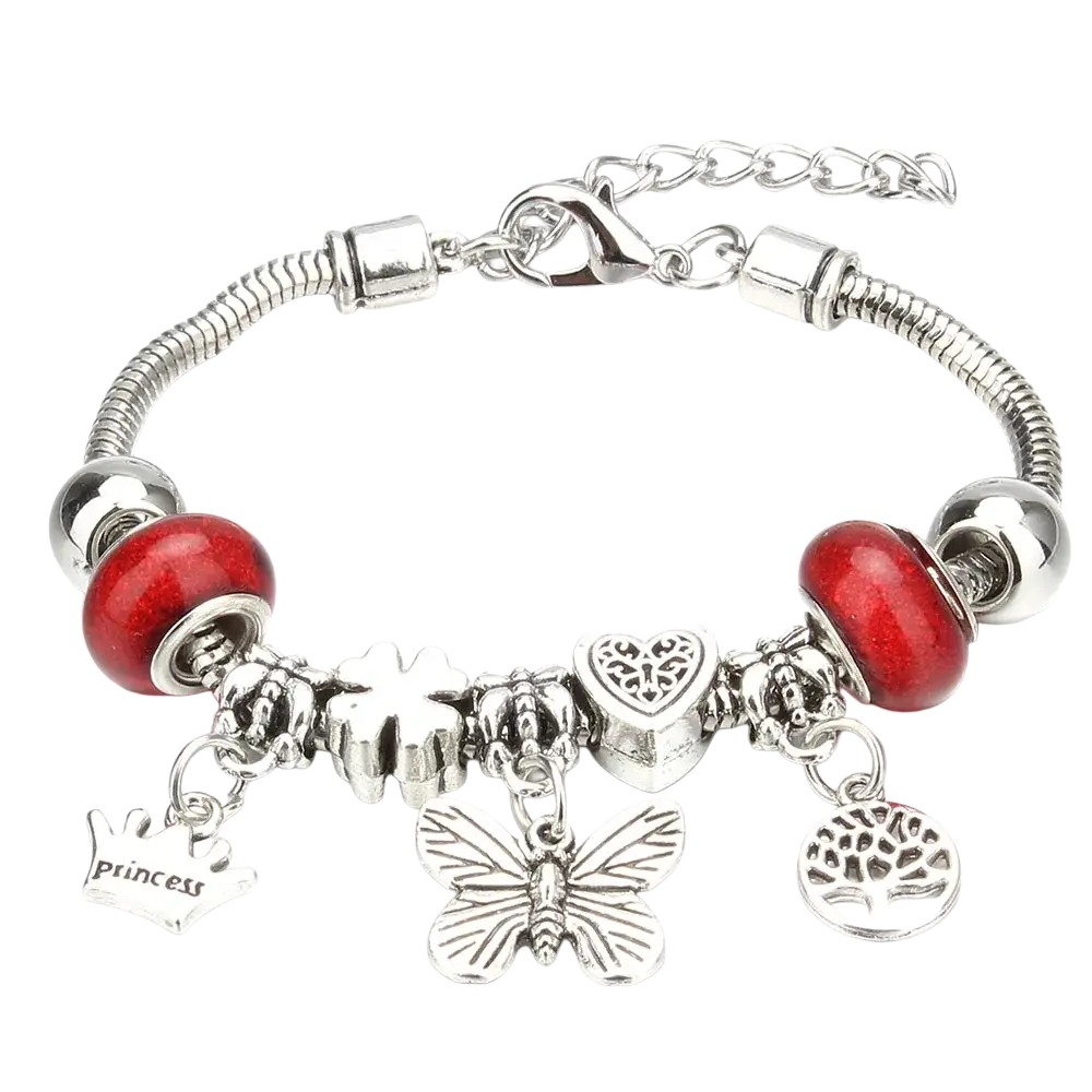 Silver-toned charm bracelet with red glass beads and metallic charms including butterfly heart crown and tree of life designs