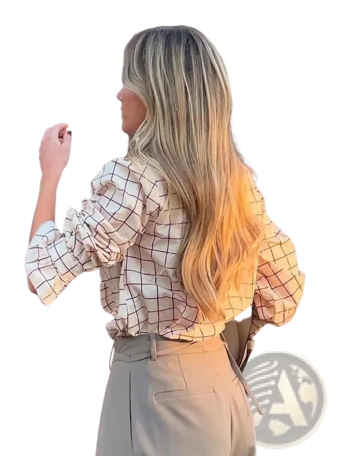 A woman wears a beige and black grid-patterned checkered ruffled chiffon blouse with puffed sleeves